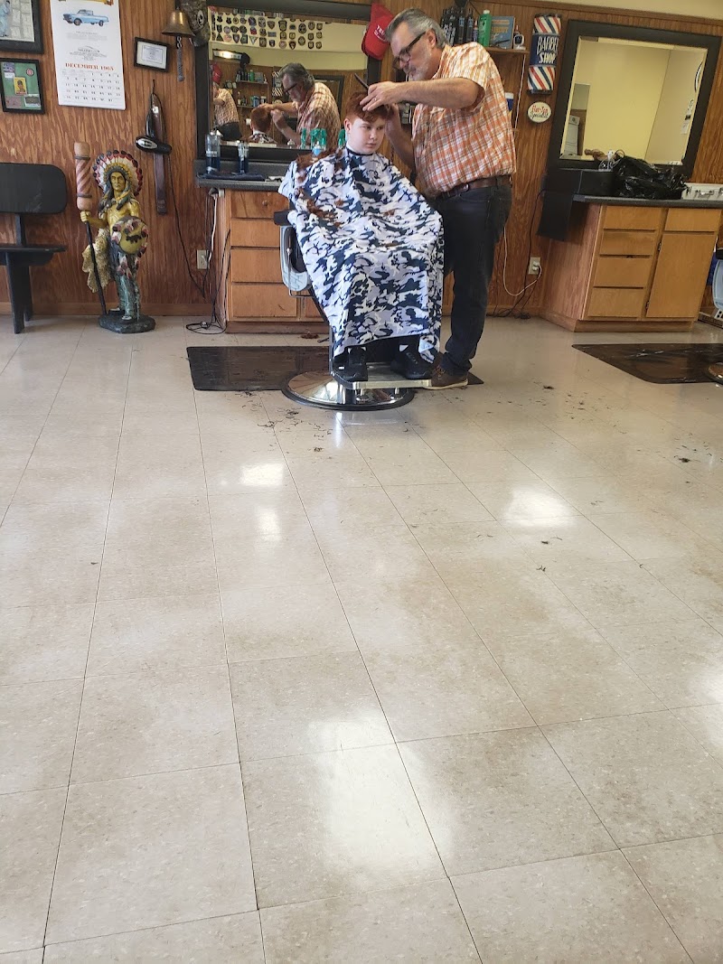 Pete carefully cutting a young boy's hair